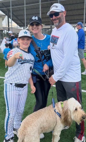 Laura's family and Astro at a baseball game